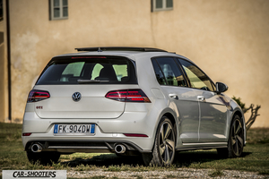 Volkswagen Golf GTI – rear three-quarter, white against an old building