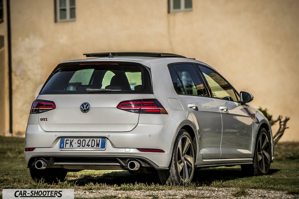 Volkswagen Golf GTI – rear three-quarter, white against an old building