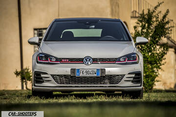 Volkswagen Golf GTI – front three-quarter, silver parked on grass outdoors