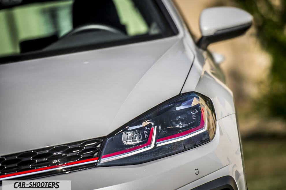 Volkswagen Golf GTI – front three-quarter, white with red grill accent
