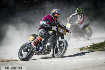 front three-quarter, black kicking up dust on a track