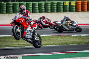 front three-quarter, red racing on a track