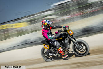 side profile, black on a dirt track