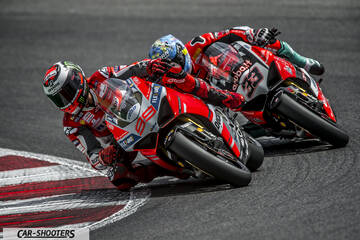front three-quarter, red racing on a track