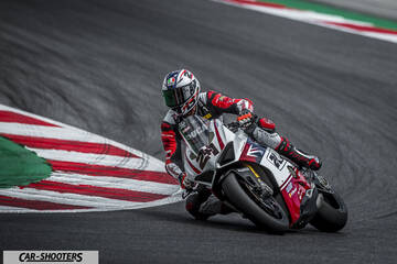 front three-quarter, white and red on a race track