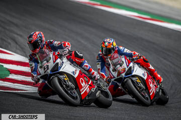 front three-quarter, white and red on a race track