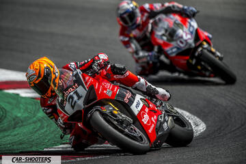 front three-quarter, red on a race track