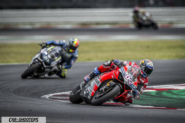 front three-quarter, red on a racetrack