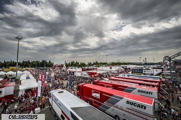 detail, at a crowded motorsport paddock