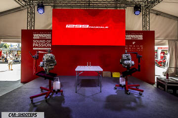 engine bay, displayed on stands at an event