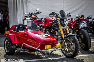 front three-quarter, red with a sidecar parked outdoors