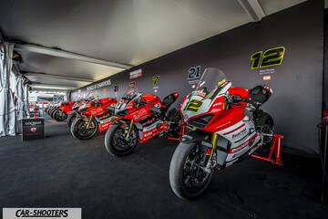 front three-quarter, red in a pit garage
