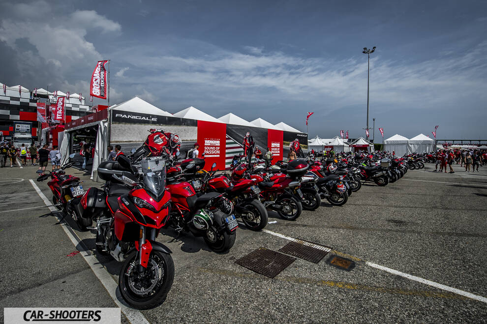 front three-quarter, red parked at a paddock event