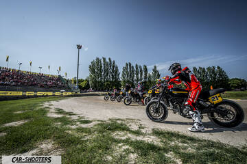 side profile, black on a dirt racing track