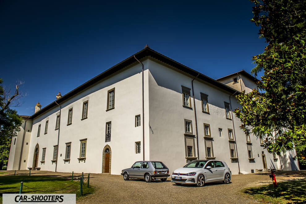 front three-quarter, silver in front of a large white building