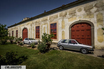side profile, silver in front of a historic building