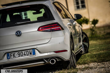 rear three-quarter, white parked on grass