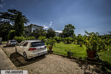 rear three-quarter, white parked near a garden