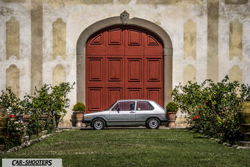 side profile, silver in front of red doors