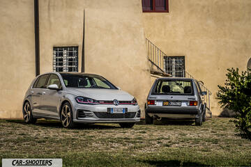 front three-quarter, silver against a rustic wall