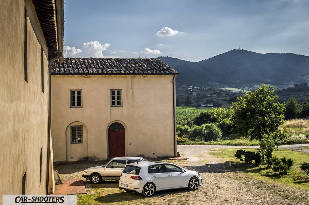 rear three-quarter, white against a mountain backdrop
