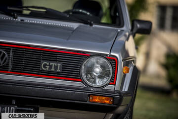 front three-quarter, silver metallic against a blurred outdoor background