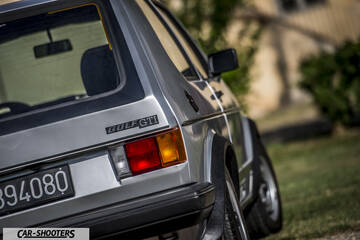 rear three-quarter, silver parked on grass