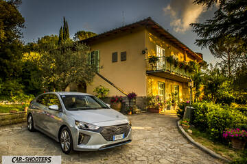 Hyundai Ioniq – front three-quarter, silver parked in front of a rustic house