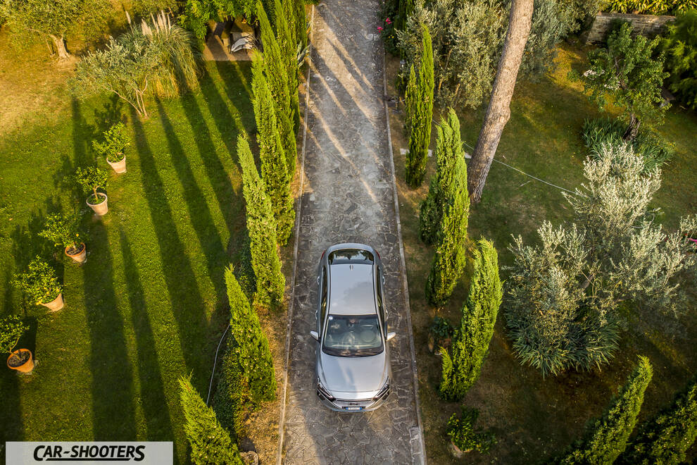 Hyundai Ioniq – front three-quarter, silver on a driveway with trees