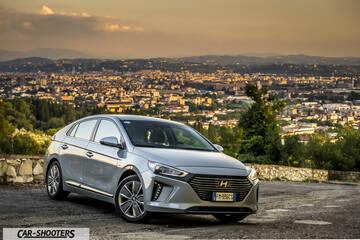 Hyundai Ioniq – front three-quarter, silver against a city backdrop