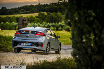 Hyundai Ioniq – rear three-quarter, silver on a country road