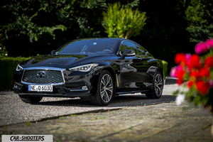 Infiniti Q60 – front three-quarter, black parked on a gravel driveway