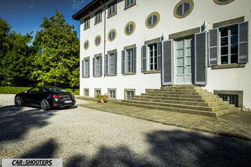Infiniti Q60 – rear three-quarter, black parked in front of a historic building
