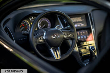 Infiniti Q60 – dashboard, leather steering wheel and dual touchscreens