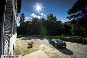 Infiniti Q60 – rear three-quarter, black parked near a historic building