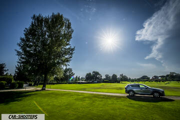 Mazda CX 5 – side profile, grey metallic on a golf course under bright sun