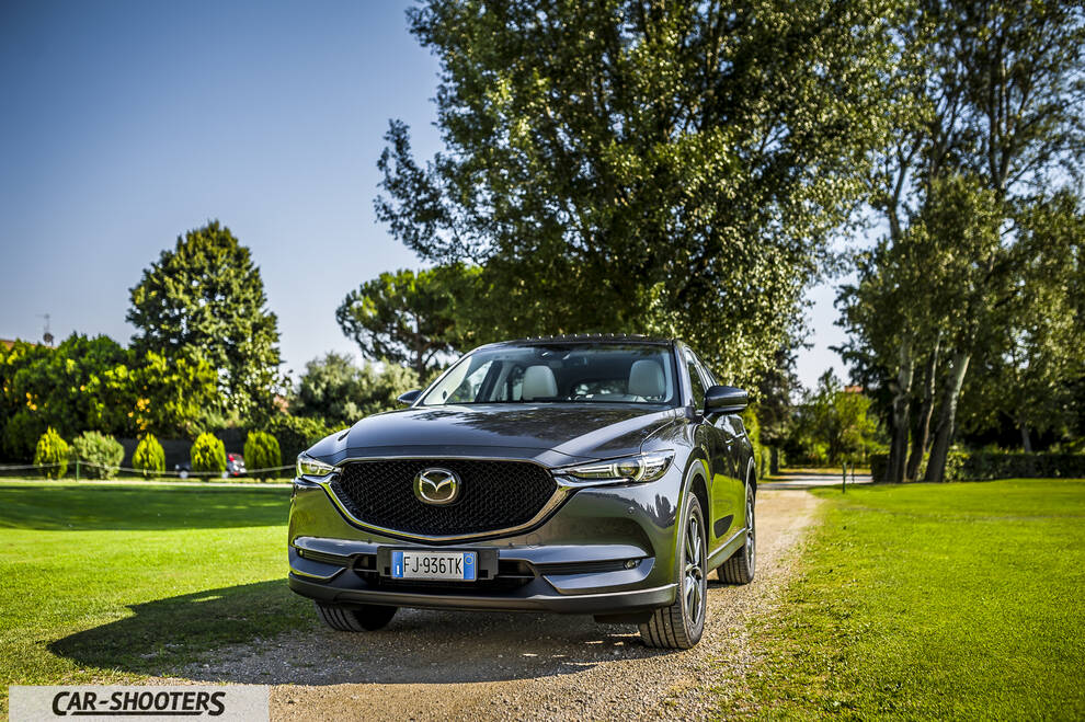 Mazda CX 5 – front three-quarter, dark grey metallic on a dirt path