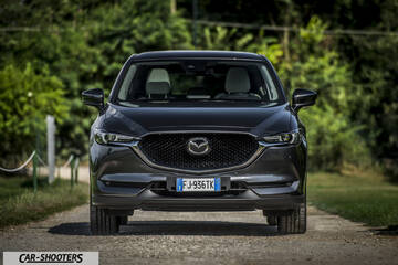 Mazda CX 5 – front three-quarter, dark grey metallic on a country road