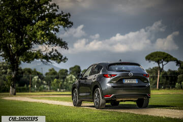 Mazda CX 5 – rear three-quarter, grey metallic on a dirt path