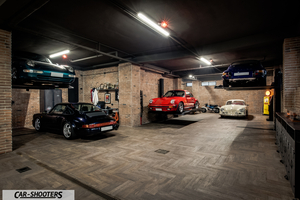 Porsche – front three-quarter, red in a multi car garage
