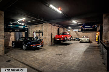 Porsche – front three-quarter, red in a multi car garage