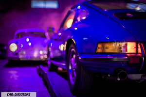 Porsche – rear three-quarter, blue in a dimly lit garage