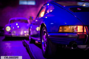 Porsche – rear three-quarter, blue in a dimly lit garage