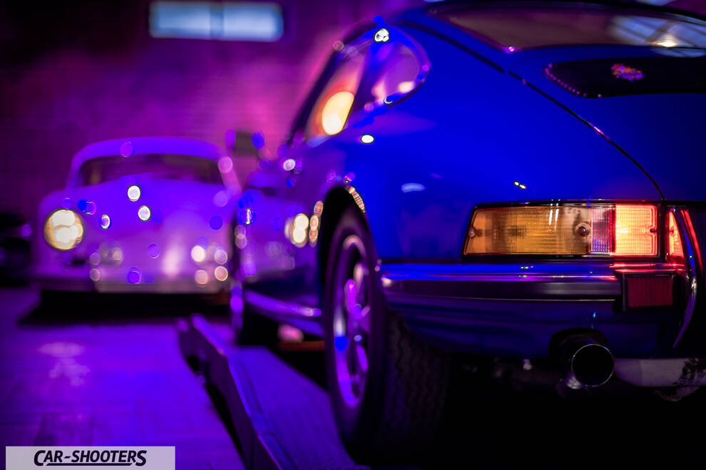Porsche – rear three-quarter, blue in a dimly lit garage