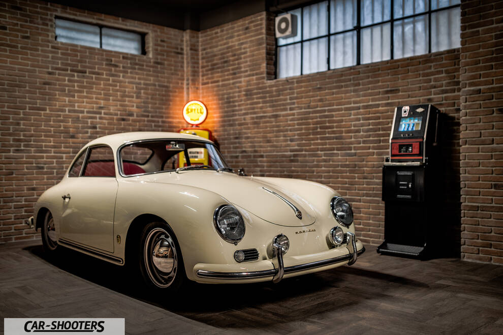 Porsche – front three-quarter, off white in a brick garage