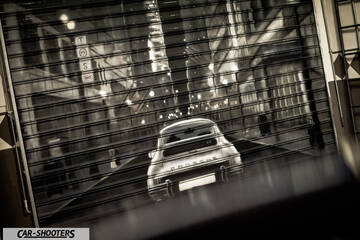 Porsche – rear view, behind a rolling shutter door