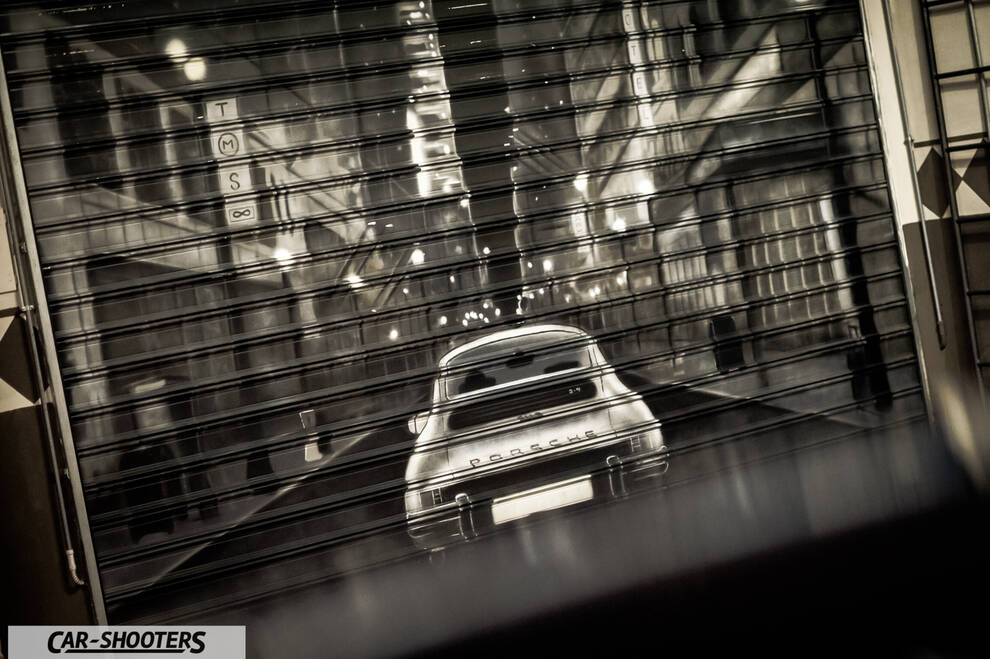 Porsche – rear view, behind a rolling shutter door