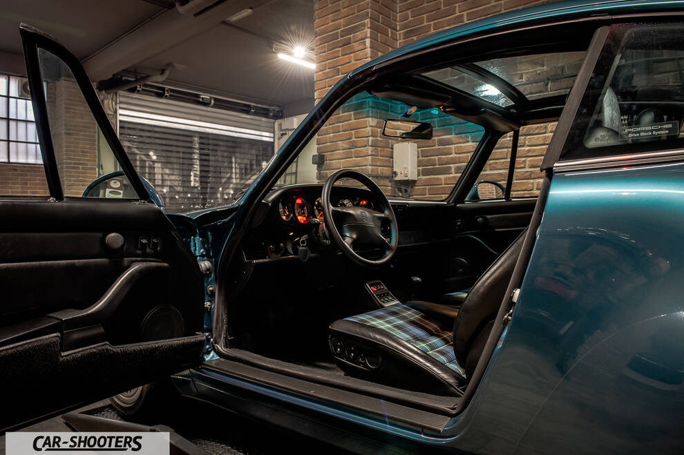 Porsche – interior, in a garage with brick walls