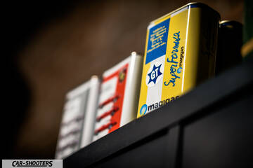 Porsche – detail, vintage oil cans on shelf