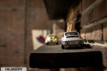 Porsche – rear view, silver on a wooden shelf